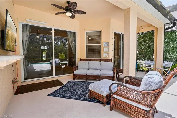 a living room with furniture and a floor to ceiling window