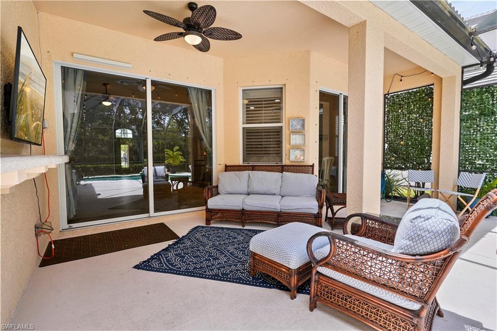 6522 Waverly Green Way Naples, FL 34110 - Photo 21 of 30 a living room with furniture and a floor to ceiling window