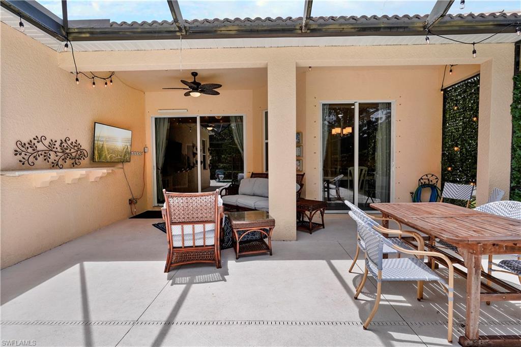 6522 Waverly Green Way Naples, FL 34110 - Photo 22 of 30 a building outdoor space with patio furniture and potted plants