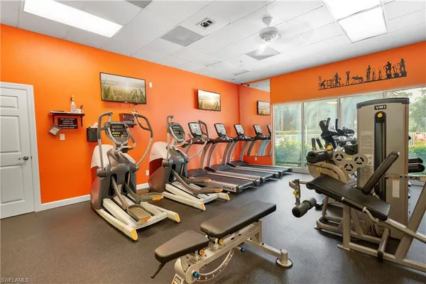 a room with gym equipment and mirror