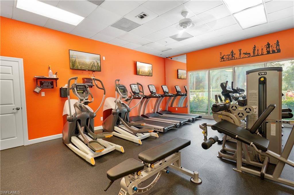 6522 Waverly Green Way Naples, FL 34110 - Photo 24 of 30 a room with gym equipment and mirror