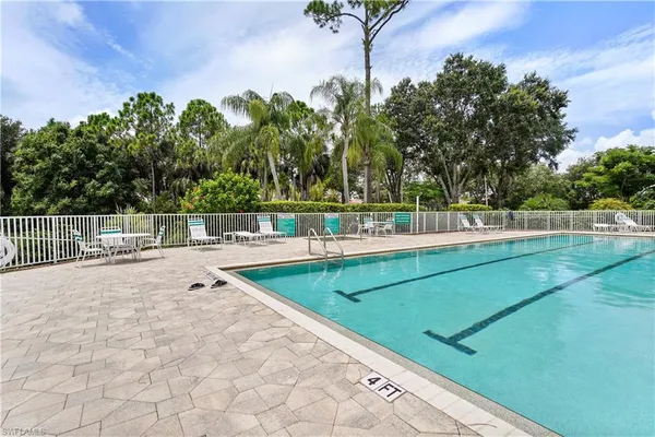 a view of a swimming pool with a lounge chair