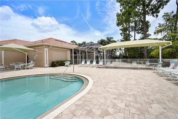 a view of a house with a swimming pool and sitting area