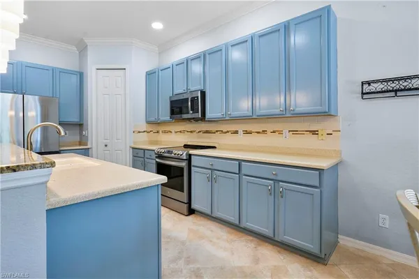 a kitchen with a stove a sink and a refrigerator
