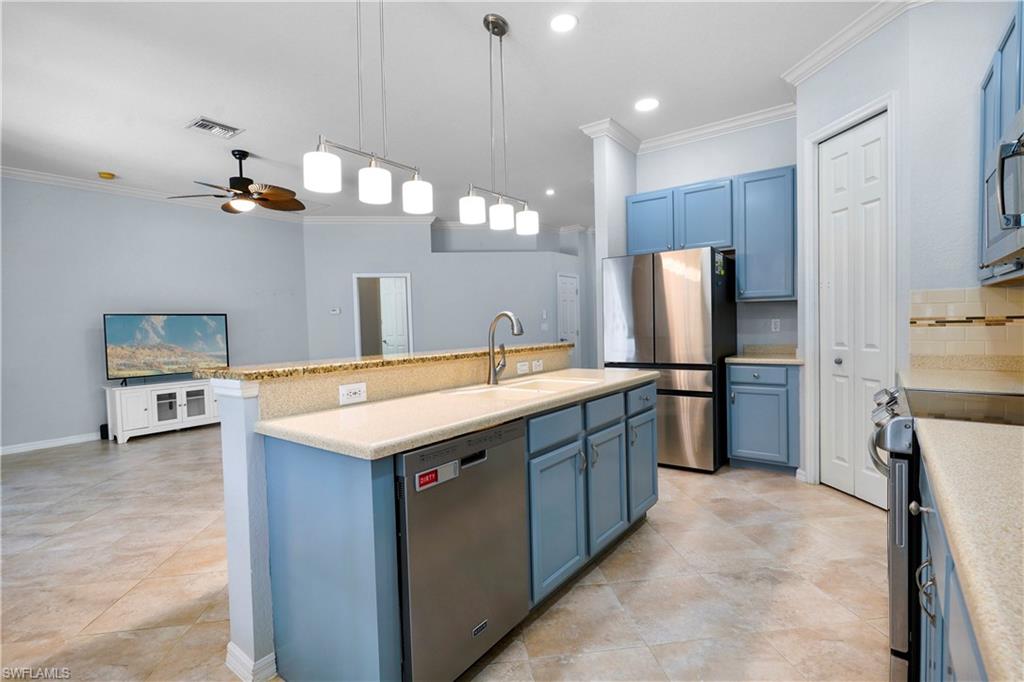 6522 Waverly Green Way Naples, FL 34110 - Photo 7 of 30 a kitchen with refrigerator cabinets and a sink