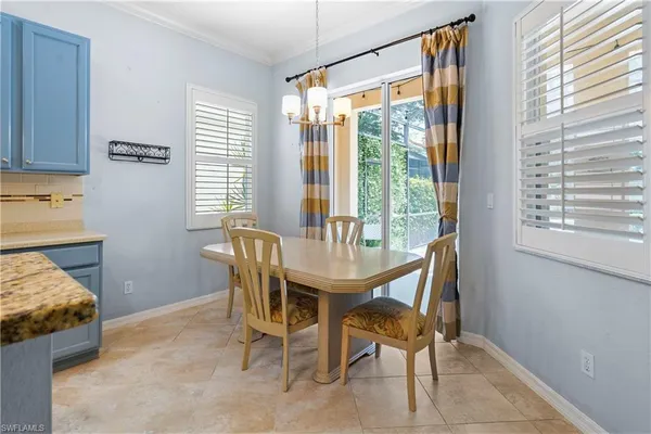 a dining room with furniture and a window