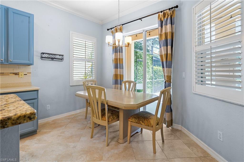 6522 Waverly Green Way Naples, FL 34110 - Photo 8 of 30 a dining room with furniture and a window