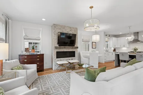 a living room with fireplace furniture and a flat screen tv