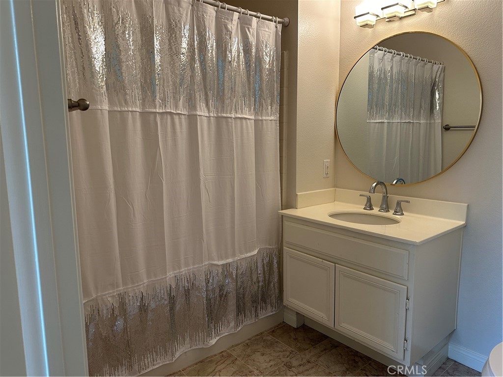 337 Chaumont Circle Lake Forest, CA 92610 - Photo 16 of 32 a bathroom with a sink a mirror and vanity