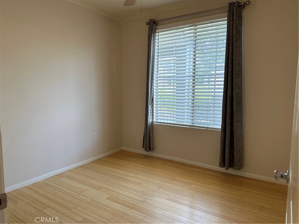 337 Chaumont Circle Lake Forest, CA 92610 - Photo 23 of 32 an empty room with wooden floor and a window
