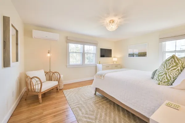a spacious bedroom with a bed and window