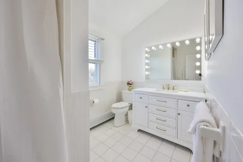 a bathroom with a double vanity sink and a mirror