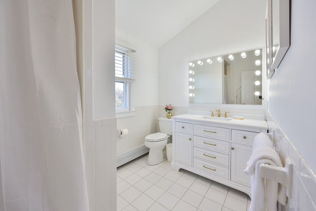63 Monomoy Road Nantucket, MA 02554 - Photo 19 of 35 a bathroom with a double vanity sink a toilet and a mirror