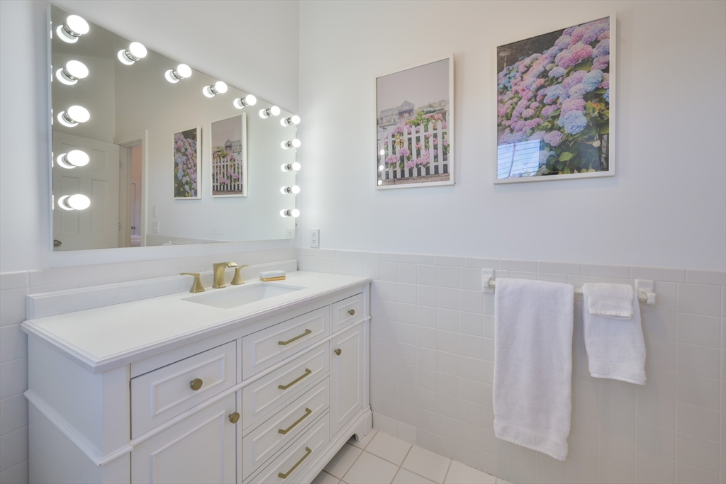 63 Monomoy Road Nantucket, MA 02554 - Photo 20 of 35 a bathroom with a double vanity sink and a mirror