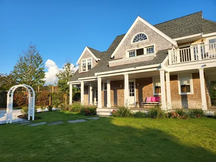 a front view of a house with a garden