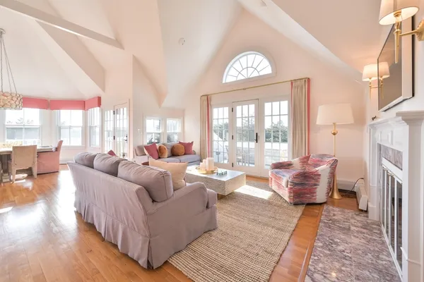a living room with furniture a fireplace and a flat screen tv