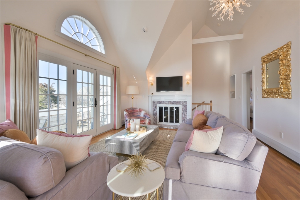 63 Monomoy Road Nantucket, MA 02554 - Photo 22 of 35 a living room with furniture a fireplace and a flat screen tv
