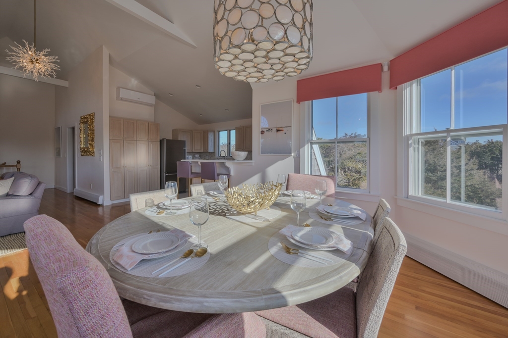 63 Monomoy Road Nantucket, MA 02554 - Photo 26 of 35 a dining room with furniture a chandelier and wooden floor