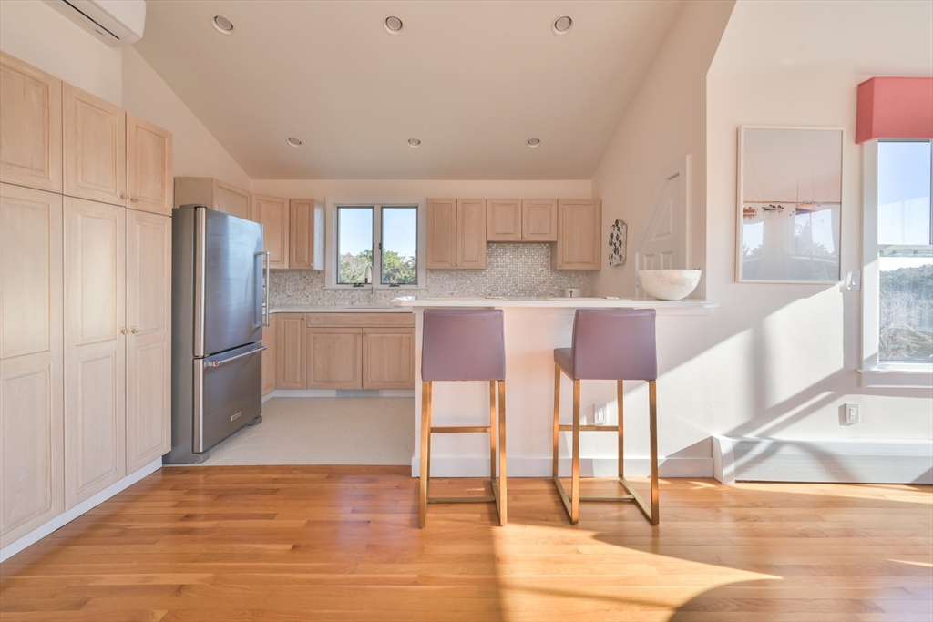 63 Monomoy Road Nantucket, MA 02554 - Photo 27 of 35 a kitchen with stainless steel appliances kitchen island granite countertop a refrigerator and a stove top oven