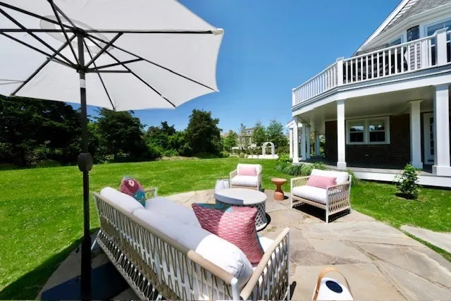 a view of a patio with couches chairs and a yard