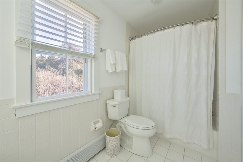 63 Monomoy Road Nantucket, MA 02554 - Photo 9 of 35 a white toilet sitting next to a window