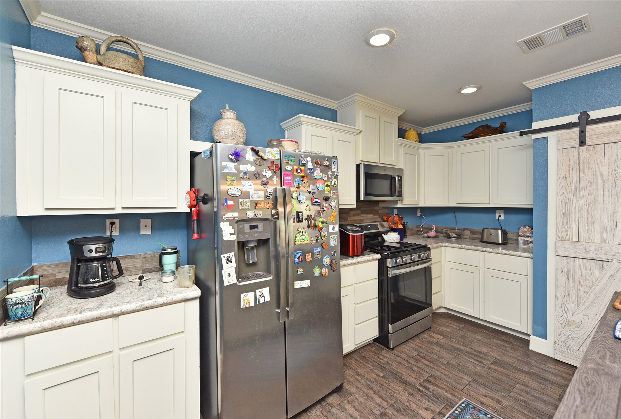 3221 Pecha Lane Rosenberg, TX 77471 - Photo 10 of 46 a kitchen with refrigerator and cabinets