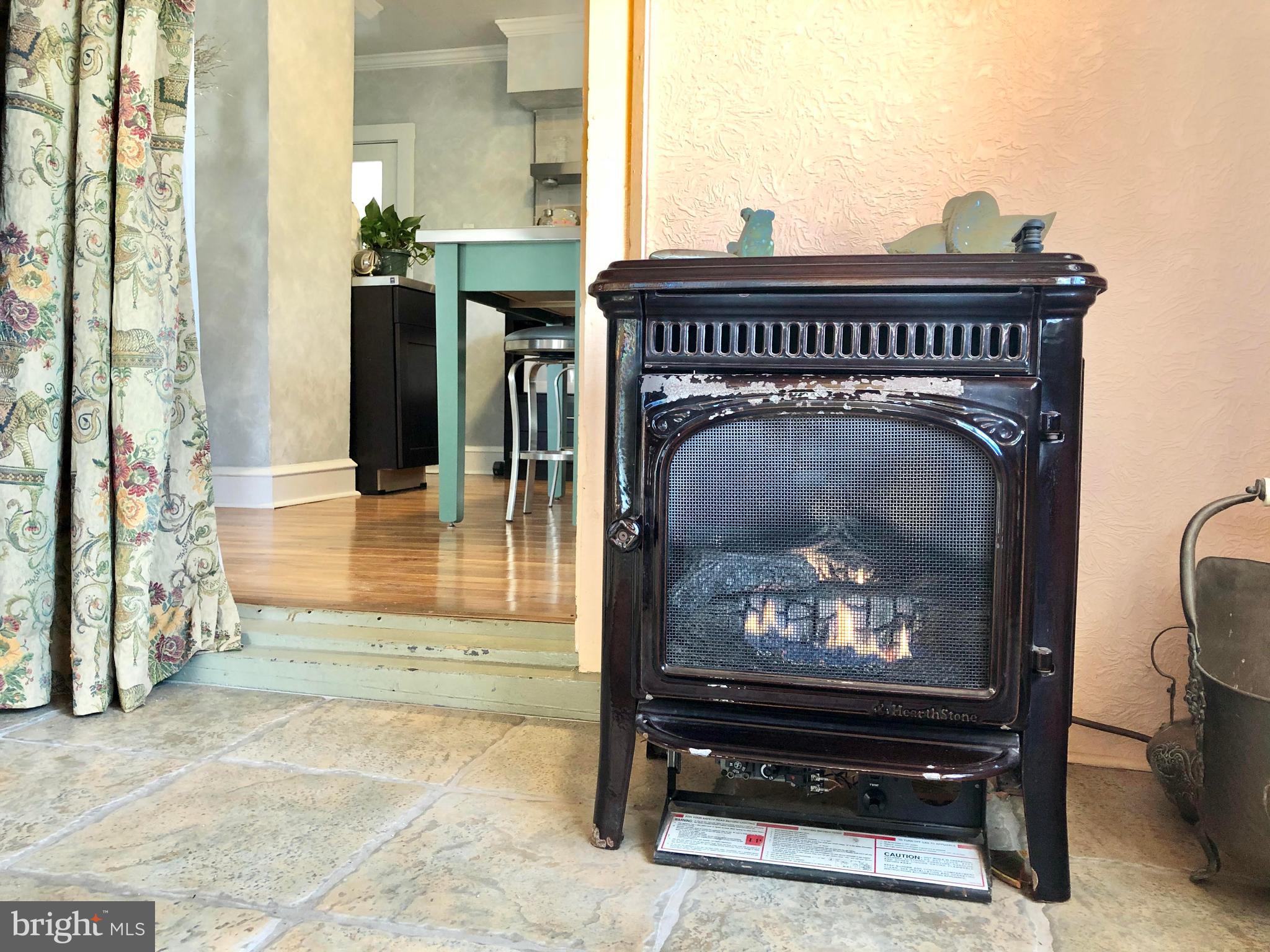 16 Station Road Leesburg, NJ 08327 - Photo 3 of 23 Gas fireplace leading into kitchen.