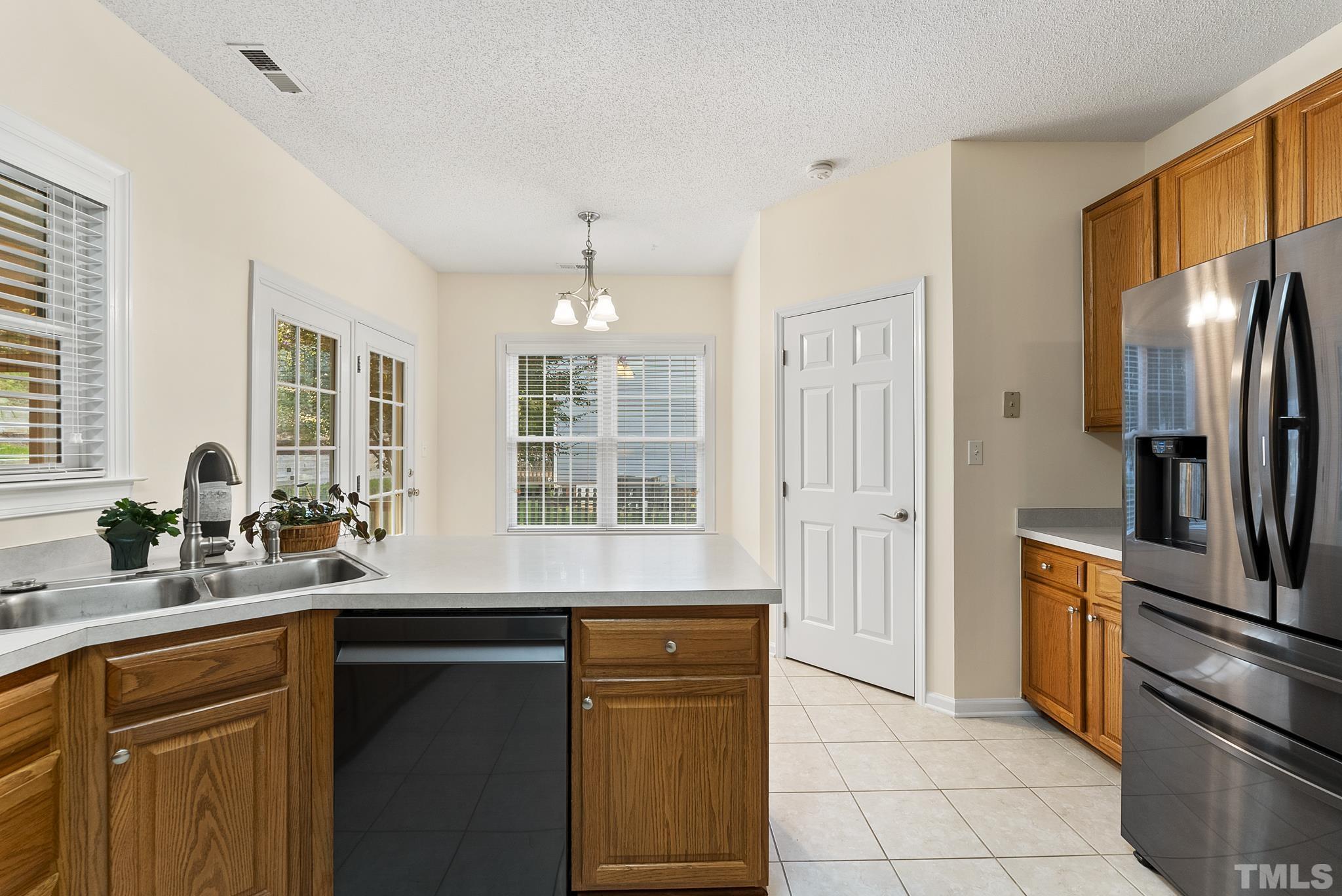 313 Catlin Road Cary, NC 27519 - Photo 11 of 27 a kitchen with a refrigerator and a sink
