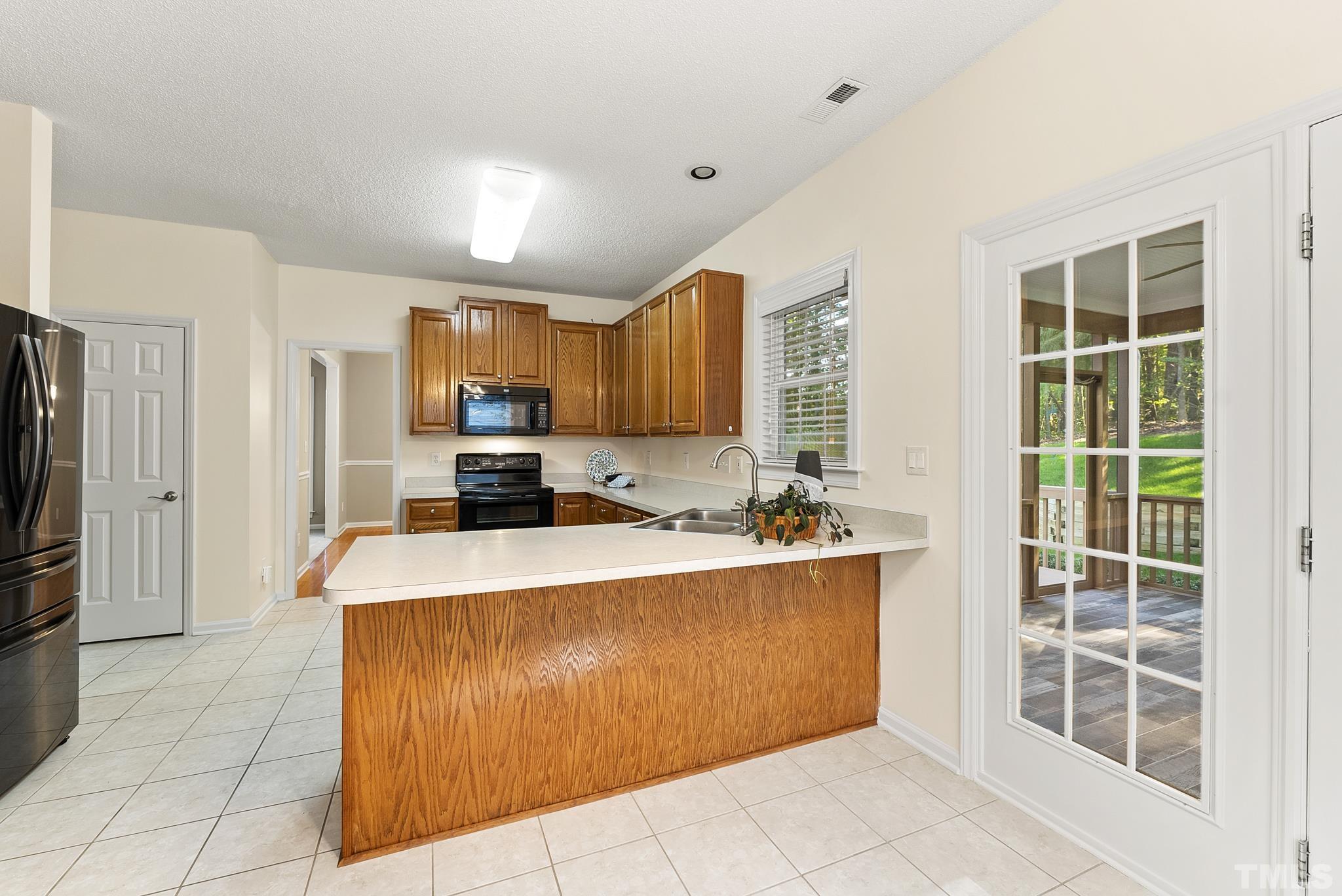 313 Catlin Road Cary, NC 27519 - Photo 13 of 27 a kitchen with stainless steel appliances granite countertop a stove top oven a refrigerator a sink and dishwasher