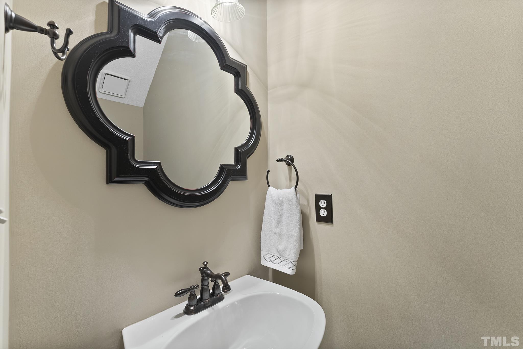 313 Catlin Road Cary, NC 27519 - Photo 14 of 27 a bathroom with a sink and mirror