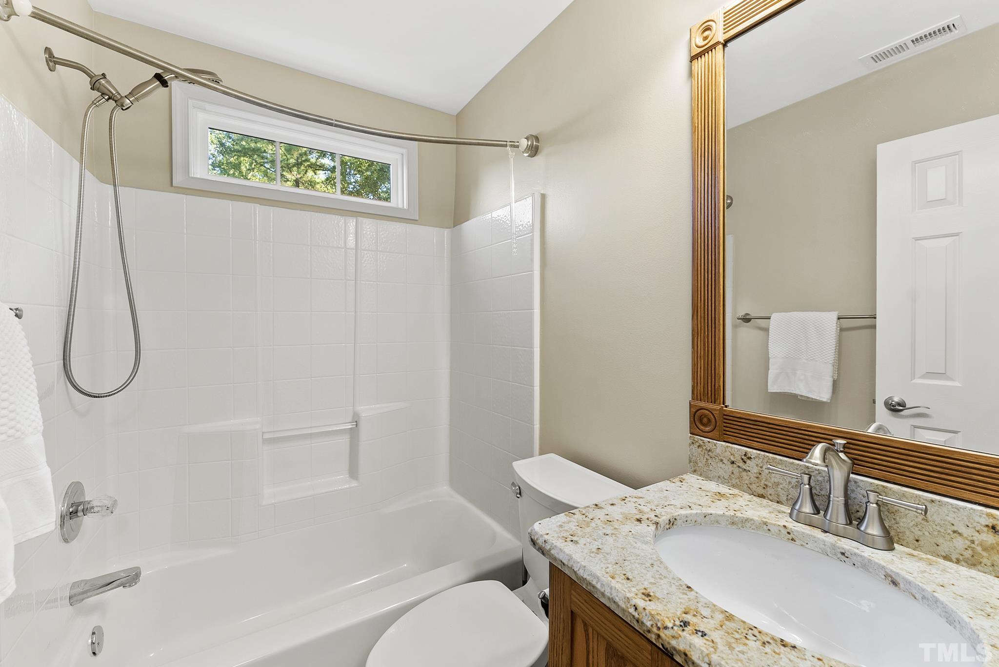 313 Catlin Road Cary, NC 27519 - Photo 21 of 27 a bathroom with a granite countertop sink a toilet and shower