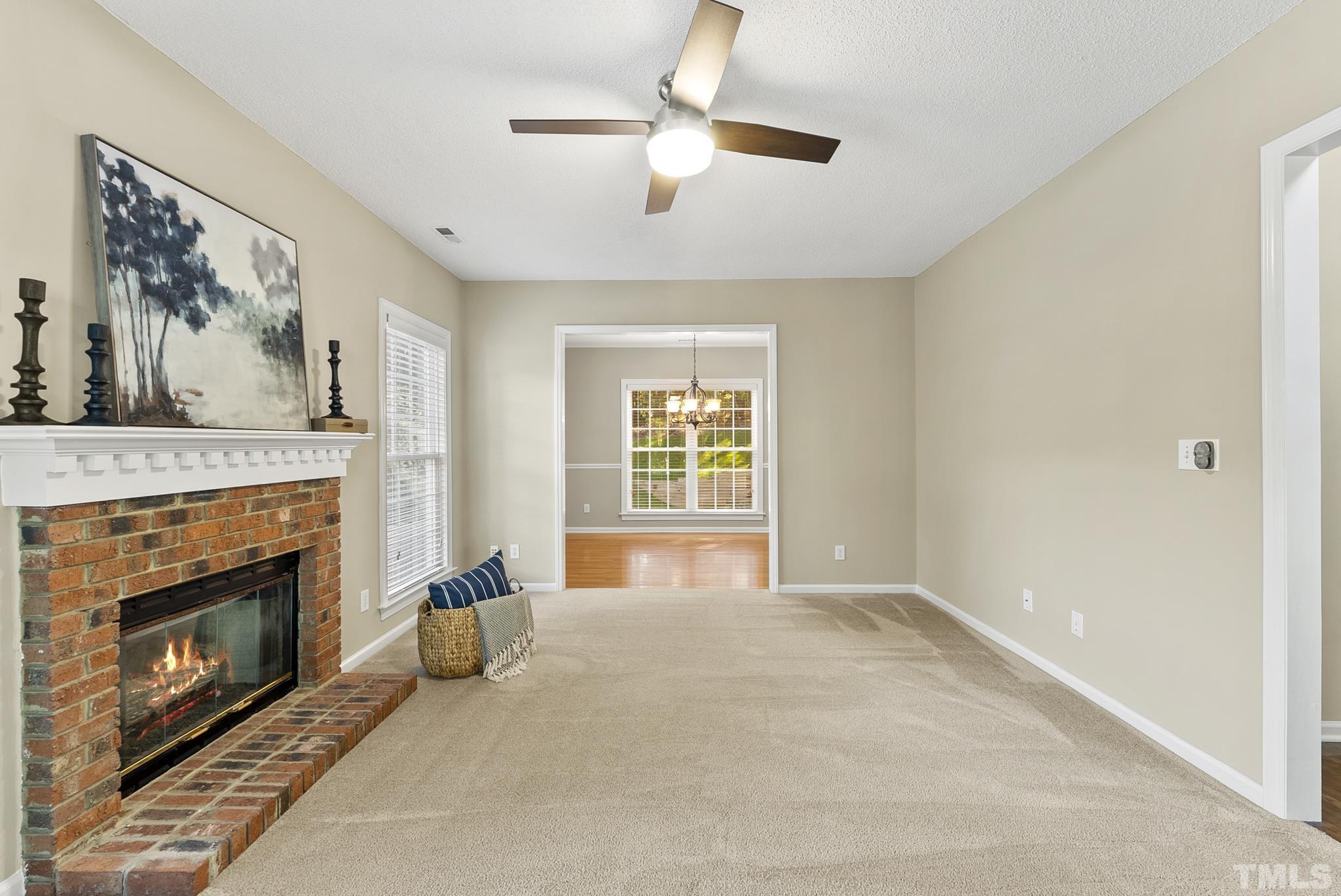 313 Catlin Road Cary, NC 27519 - Photo 6 of 27 a living room with furniture and a fireplace