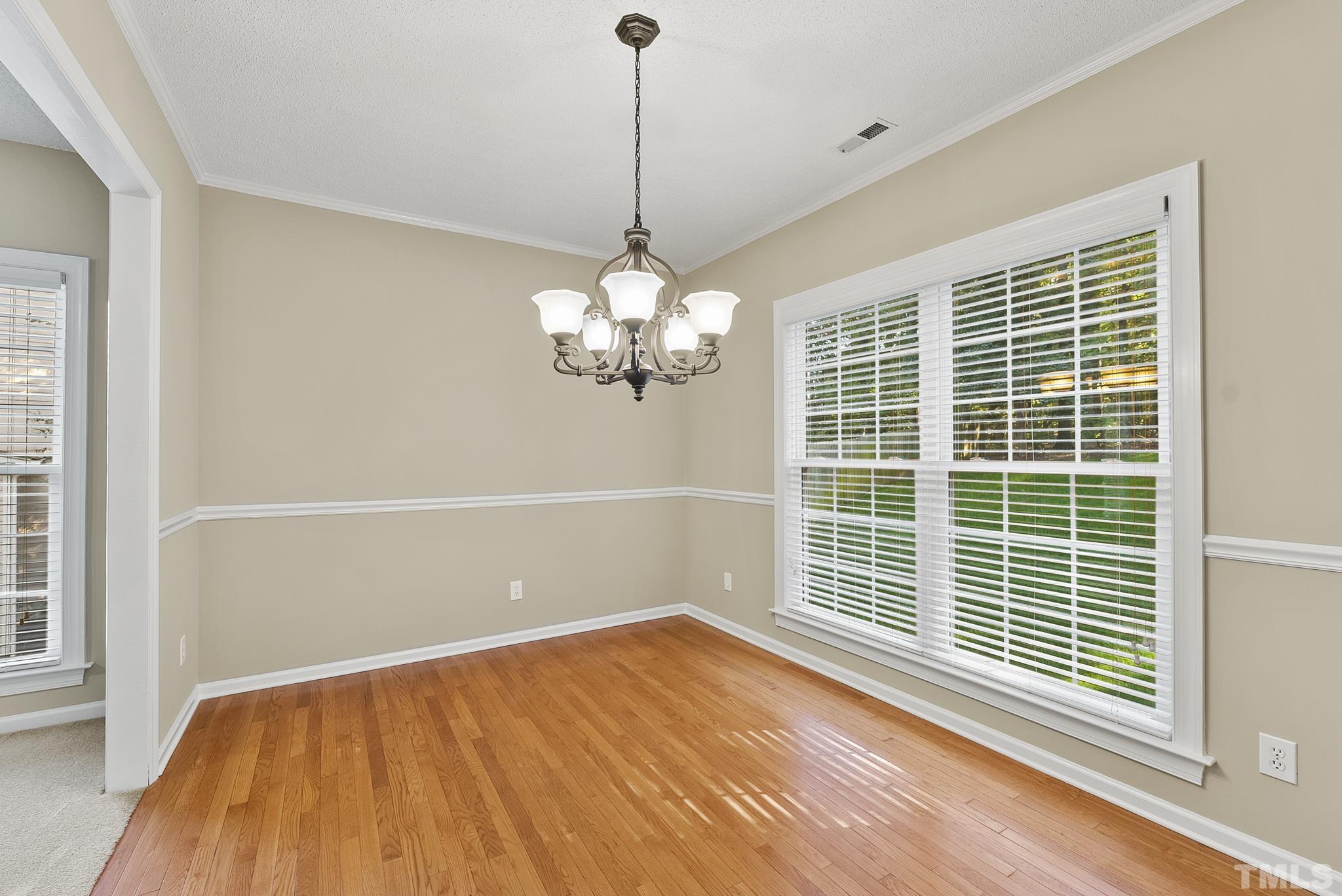 313 Catlin Road Cary, NC 27519 - Photo 7 of 27 a view of empty room with wooden floor and fan