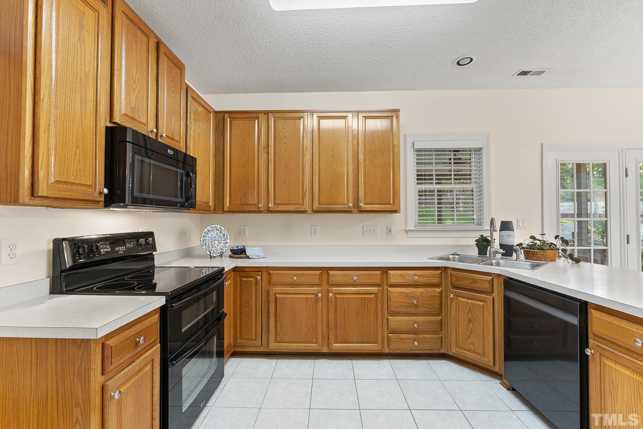 313 Catlin Road Cary, NC 27519 - Photo 8 of 27 a kitchen with a sink stove top oven and cabinets