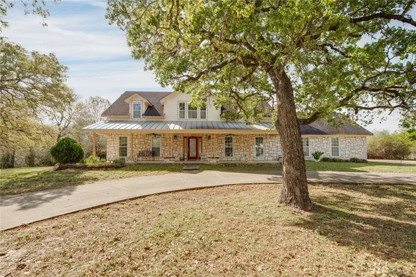 a view of a large trees in front of a house