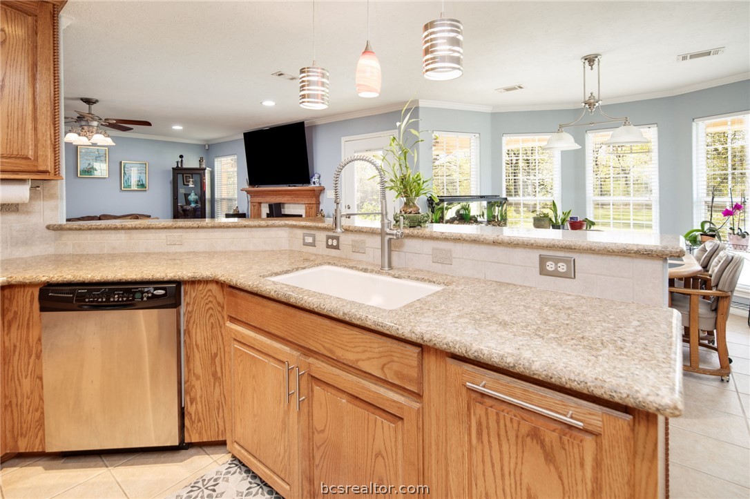209 Ranchette Court Bryan, TX 77808 - Photo 12 of 37 a large kitchen with granite countertop a sink a counter top space and cabinets