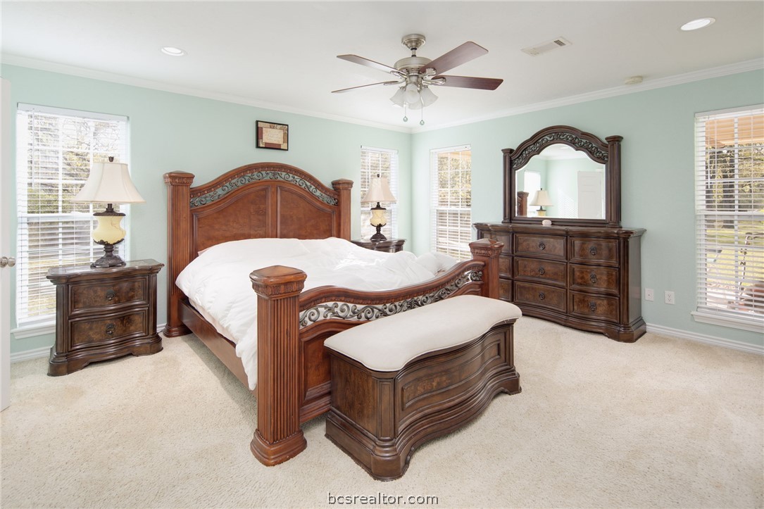 209 Ranchette Court Bryan, TX 77808 - Photo 16 of 37 a bedroom with a bed and a dresser