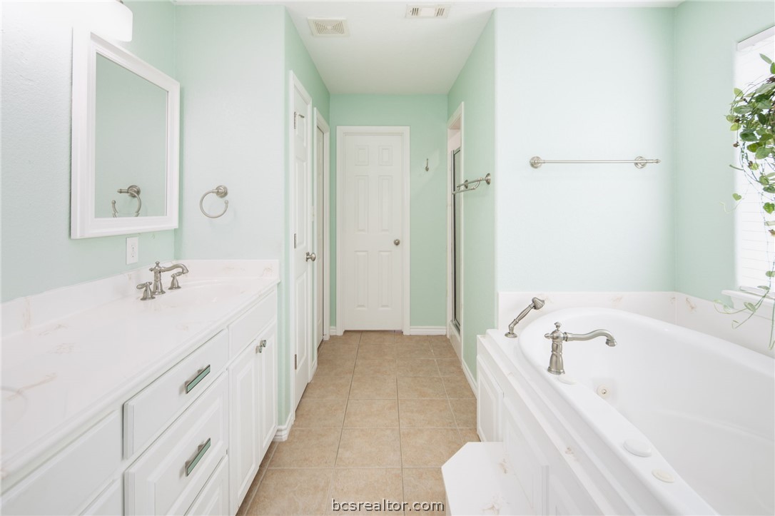 209 Ranchette Court Bryan, TX 77808 - Photo 17 of 37 a spacious bathroom with a tub sink and mirror