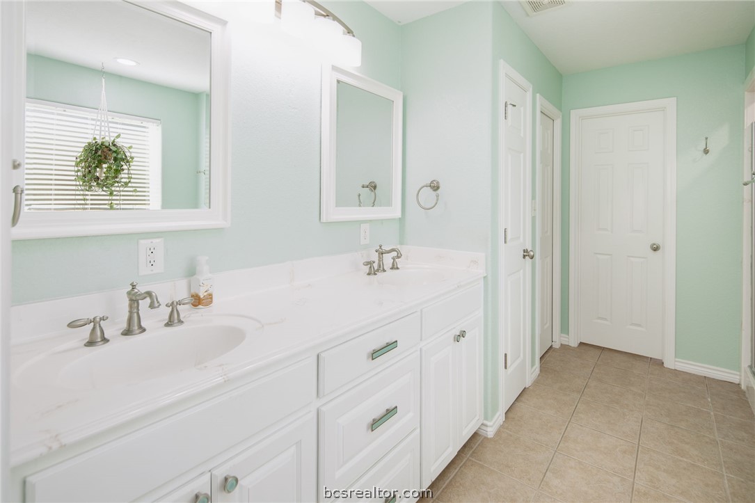 209 Ranchette Court Bryan, TX 77808 - Photo 18 of 37 a bathroom with double vanity sink a mirror and a window