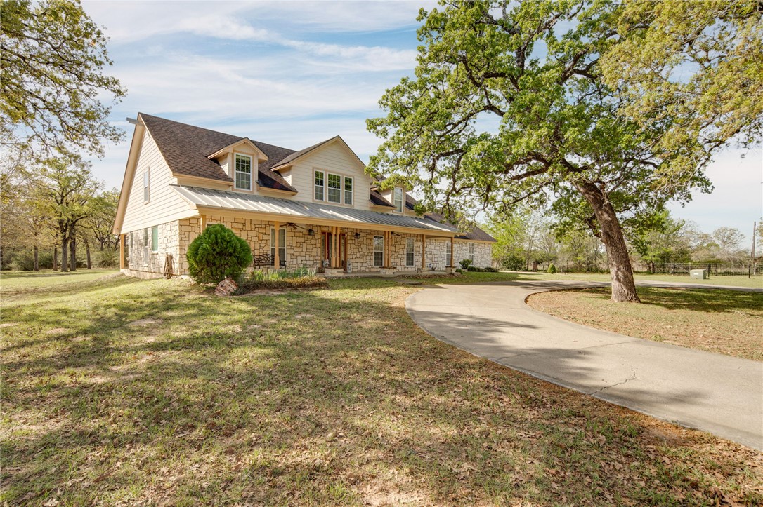 209 Ranchette Court Bryan, TX 77808 - Photo 2 of 37 a front view of a house with a yard