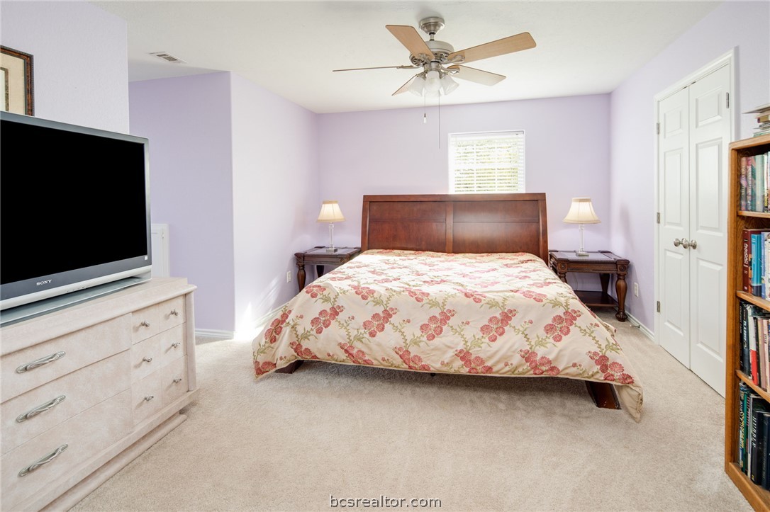 209 Ranchette Court Bryan, TX 77808 - Photo 21 of 37 a bedroom with a bed tv and a dresser
