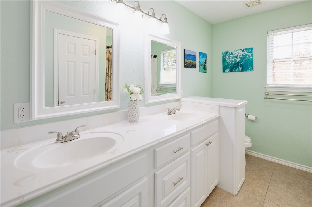 209 Ranchette Court Bryan, TX 77808 - Photo 24 of 37 a bathroom with double sink and a mirror
