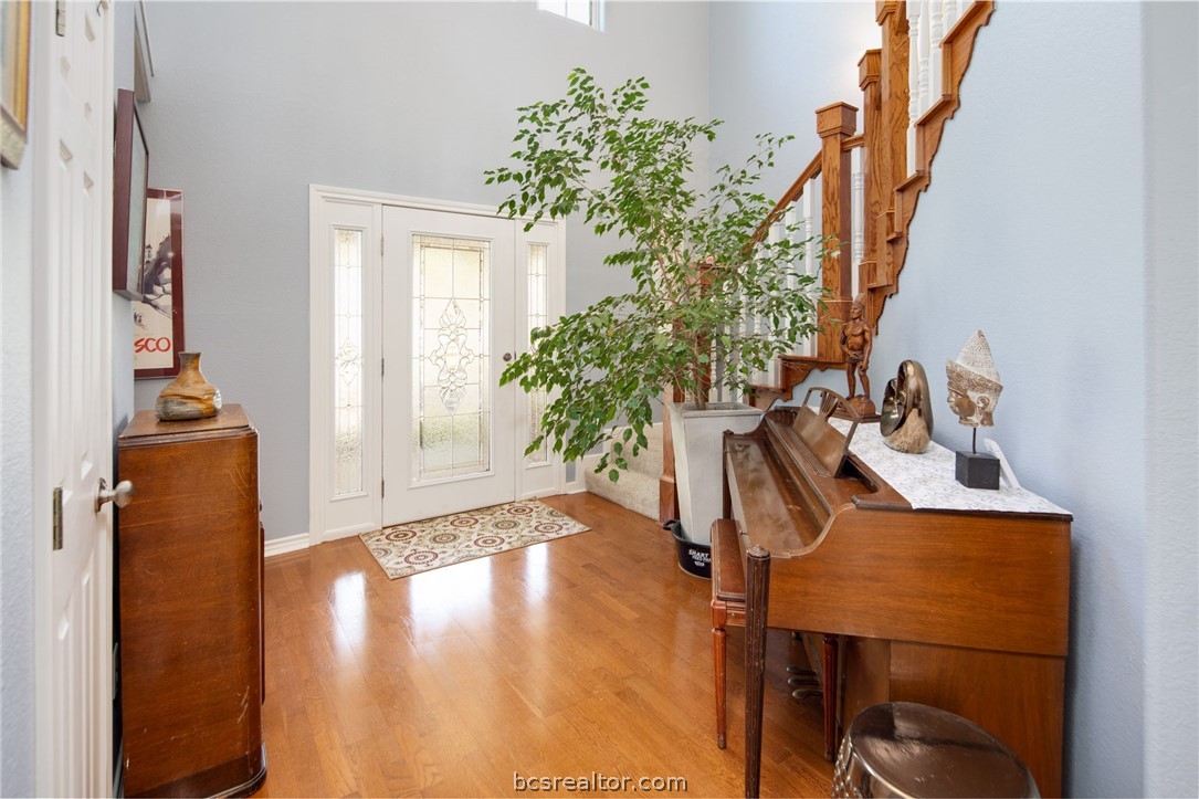 209 Ranchette Court Bryan, TX 77808 - Photo 7 of 37 a view of a room with wooden floor and potted plant