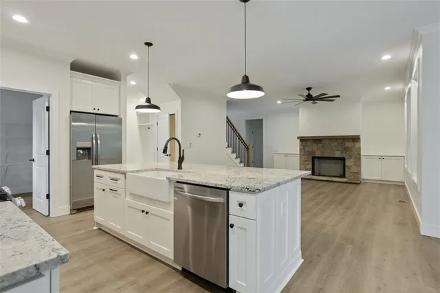 a dining room with furniture a chandelier and wooden floor