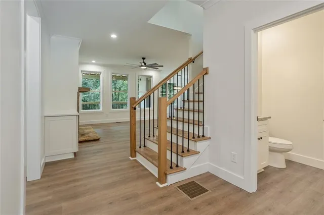 a view of an empty room with a fireplace and a window