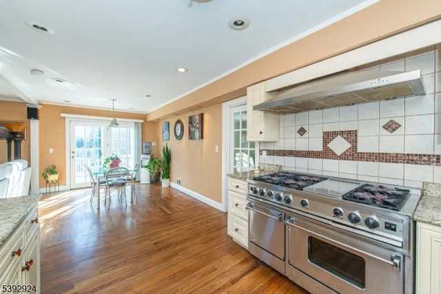 a kitchen with stove and chairs