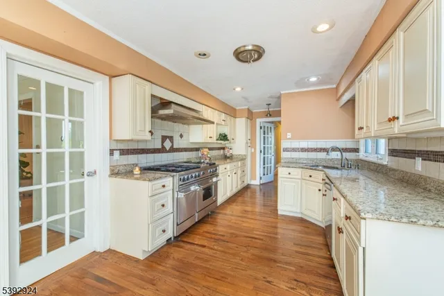 a kitchen with stainless steel appliances granite countertop a stove and a sink