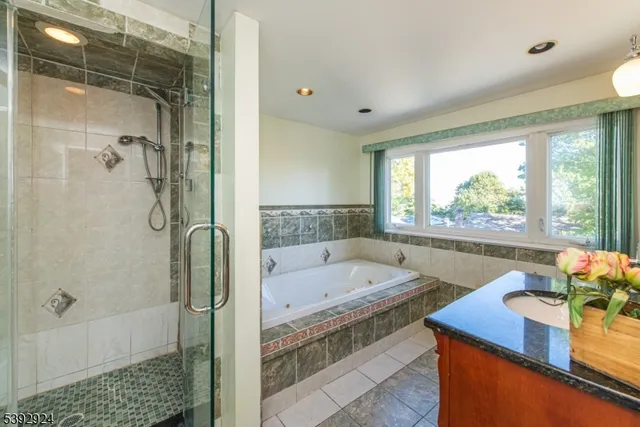 a bathroom with a tub sink and shower