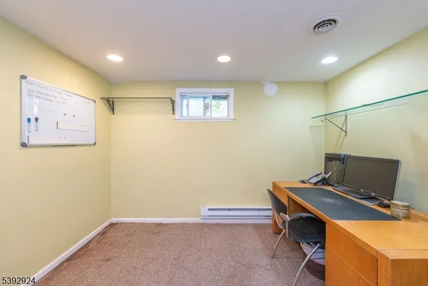 a view of workspace with paintings on the wall