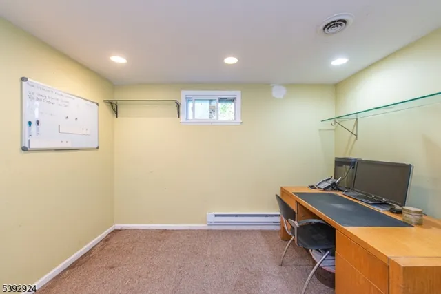 a view of workspace with paintings on the wall